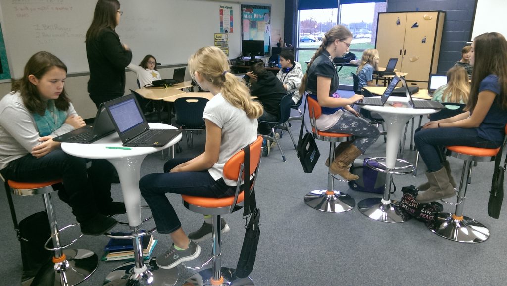 Students at Cascade Middle School test out new classroom furniture donated by Orange Leaf Frozen Yogurt. It's helped to update classroom design at the school -- an important aspect of learning. (Photo via Eric Sieferman)