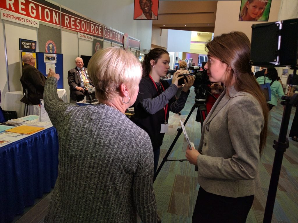 Hoover High School students Carly Sabella (right) and Hayden Kearns (behind) create video at the Ohio School Board Association annual conference. (Photo by Matt Miller)